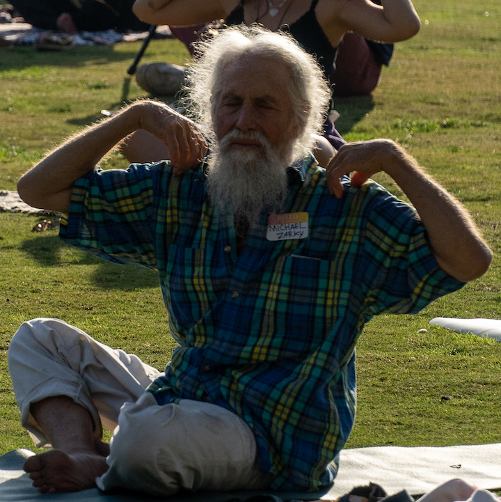 Man practicing yoga on lawn